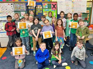 Students hold up Global Collaboration project ideas